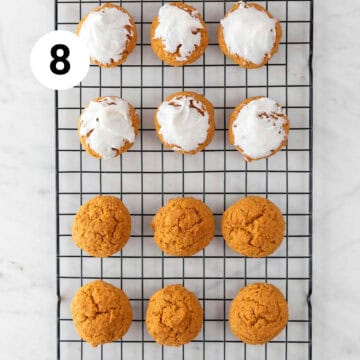 Baked vegan pumpkin cookies onto a cooling rack, some with frosting.