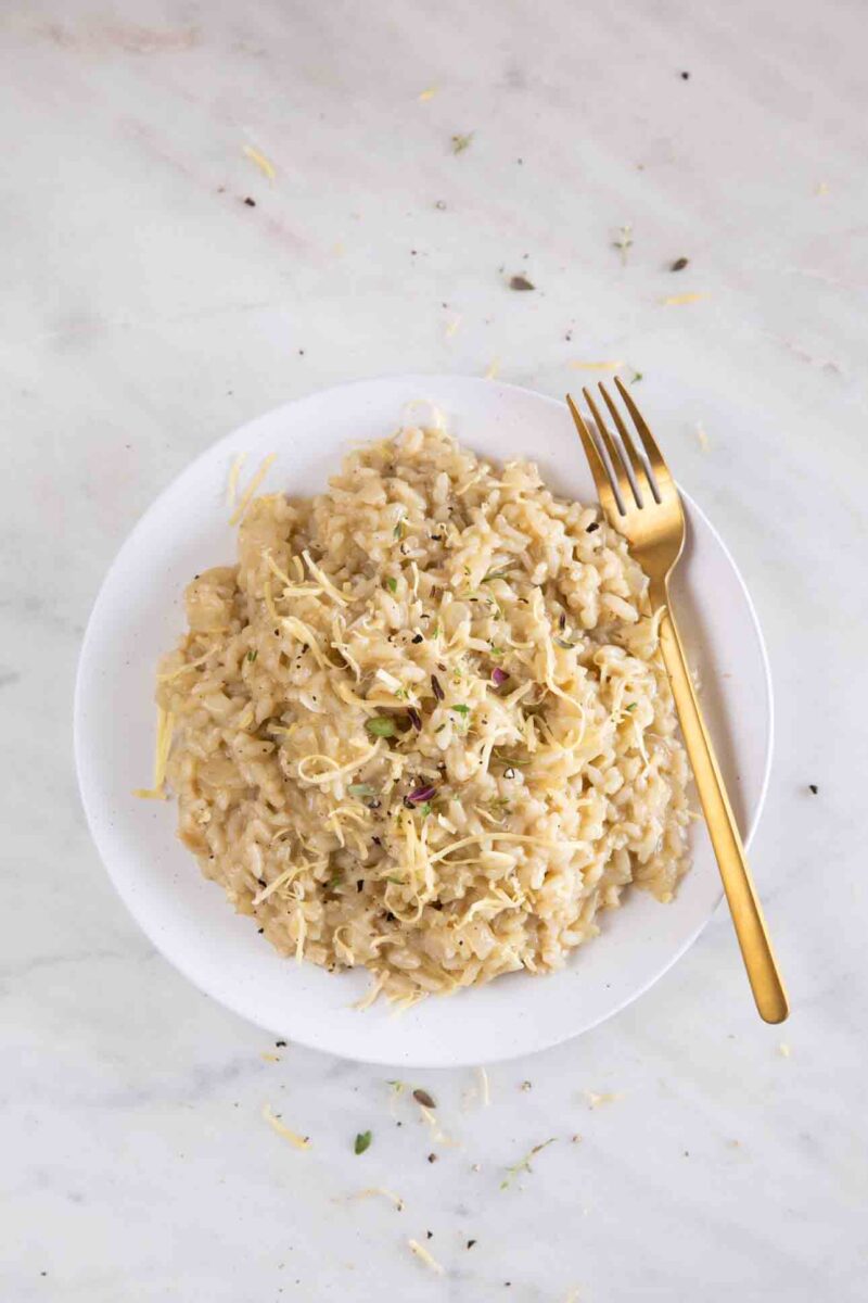 Photo from above of a dish of vegan risotto with a fork