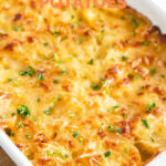 Photo of a casserole of vegan scalloped potatoes with the words vegan scalloped potatoes