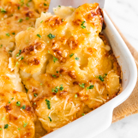 Square photo of a casserole of vegan scalloped potatoes