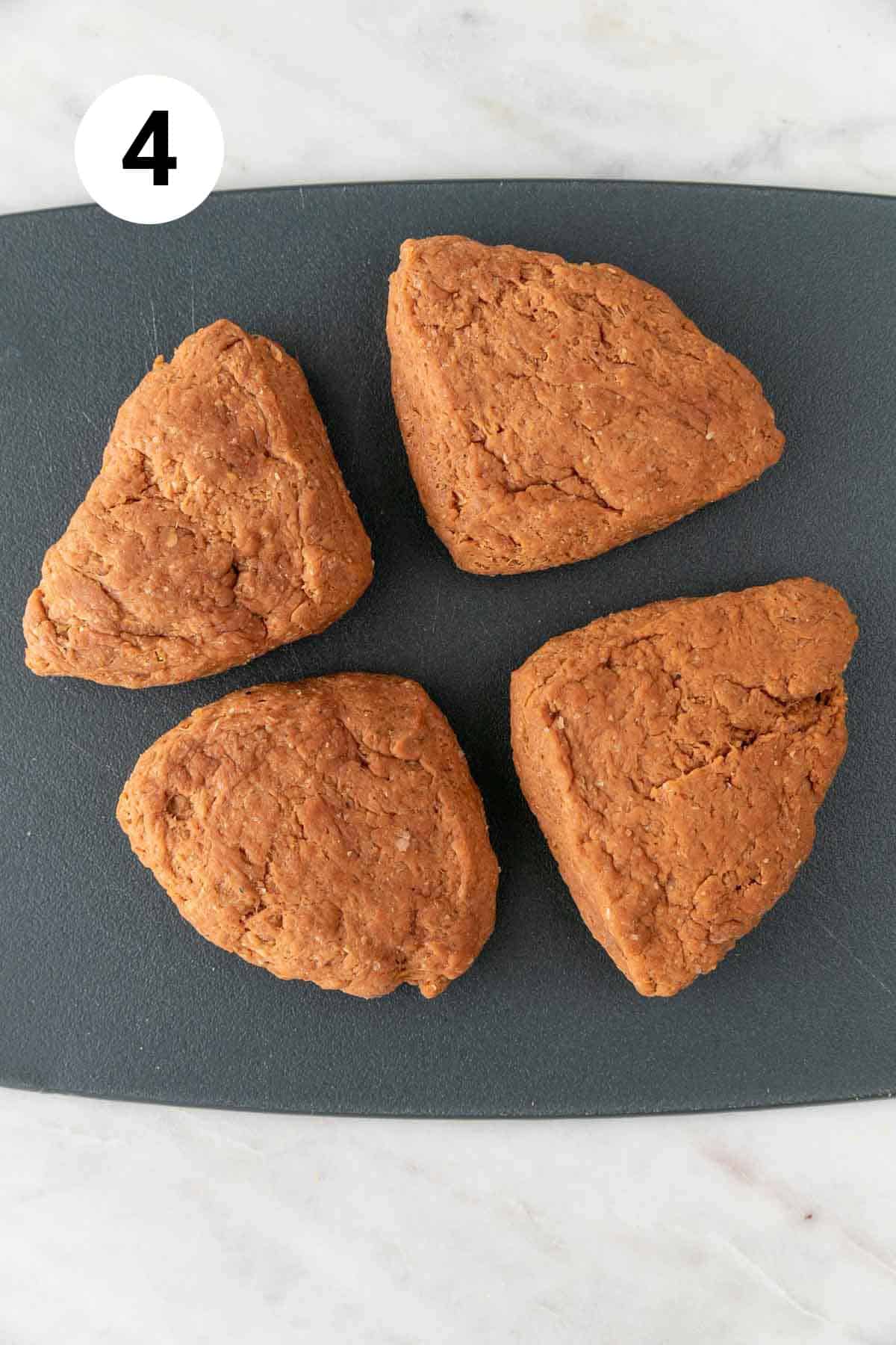 The dough ball flattened and cut into 4 pieces.