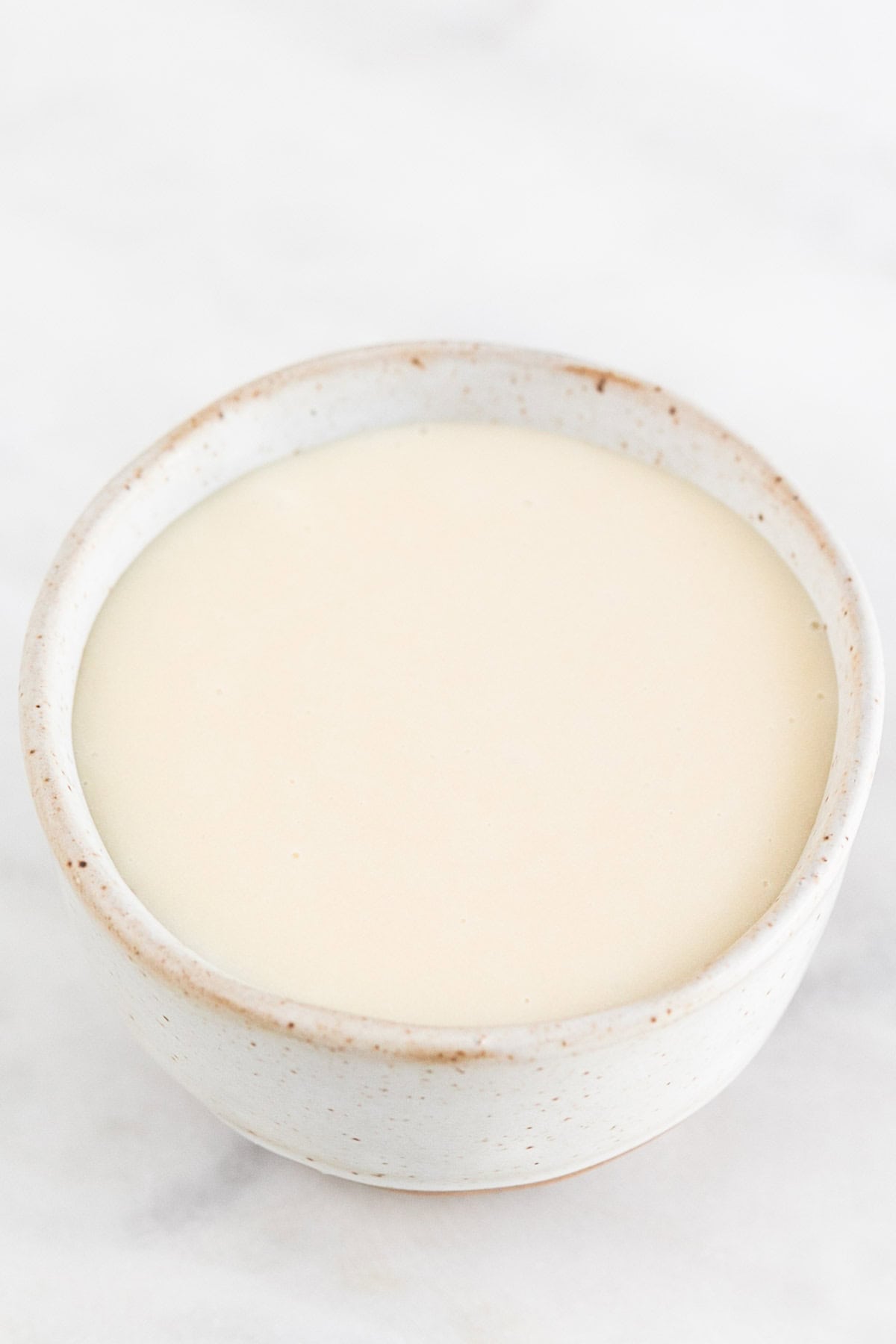 Vegan sweetened condensed milk in a small bowl.
