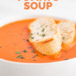 Close-up photo of a vegan tomato soup with the words vegan tomato soup
