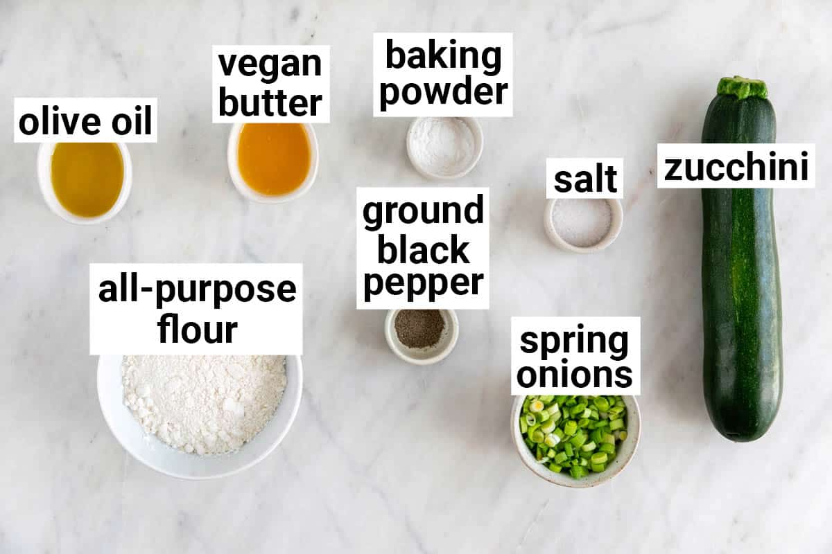 Ingredients needed to make vegan zucchini fritters.