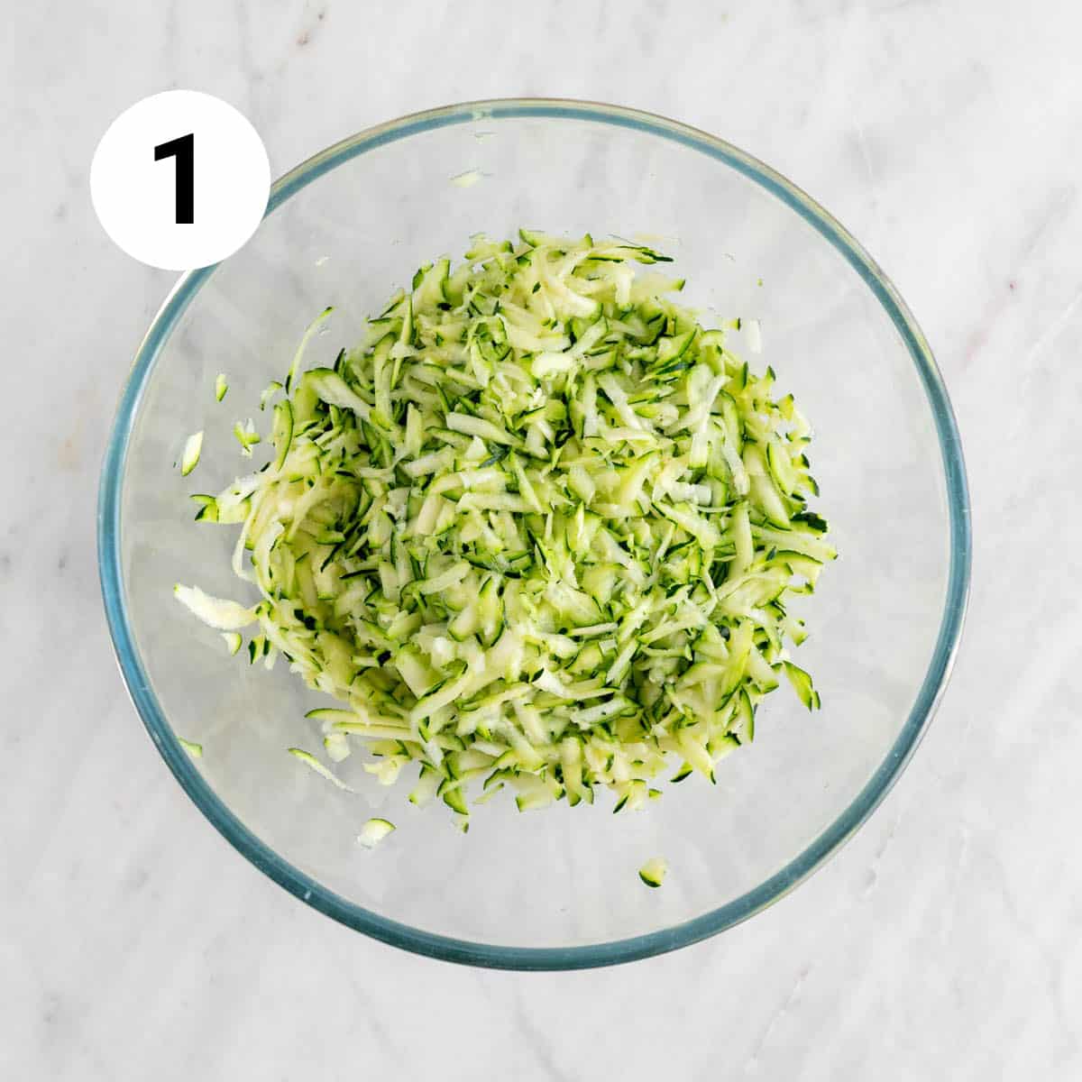 Grated zucchini in a bowl.