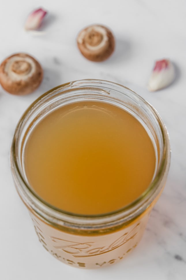 Close-up photo of a glass jar of vegetable stock