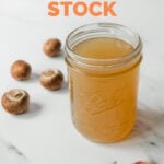 Photo of a glass jar of vegetable stock with the words how to make vegetable stock